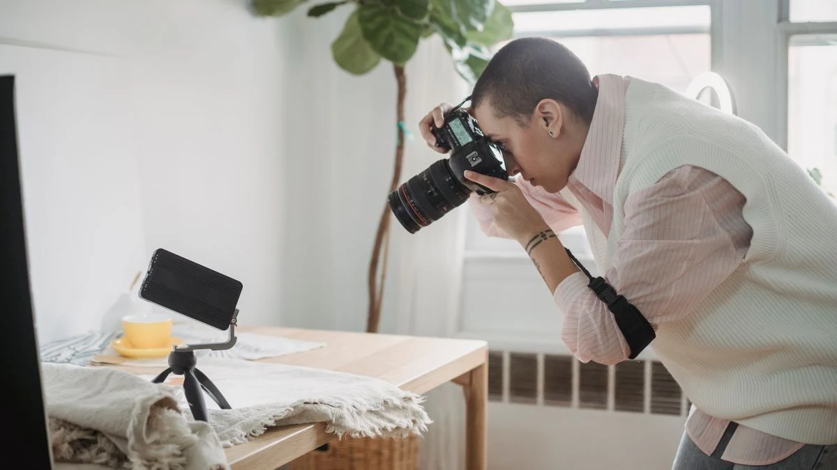 Photographer taking photos with a DSLR in a bright creative studio