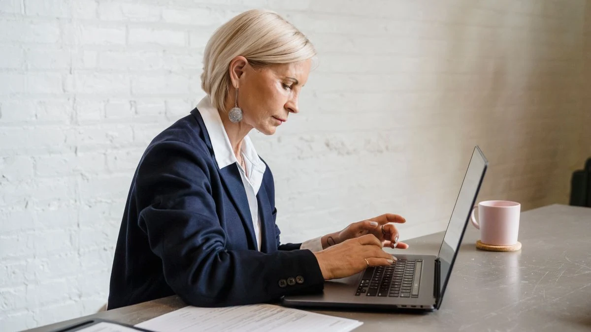 Professional typing on a laptop in a contemporary office